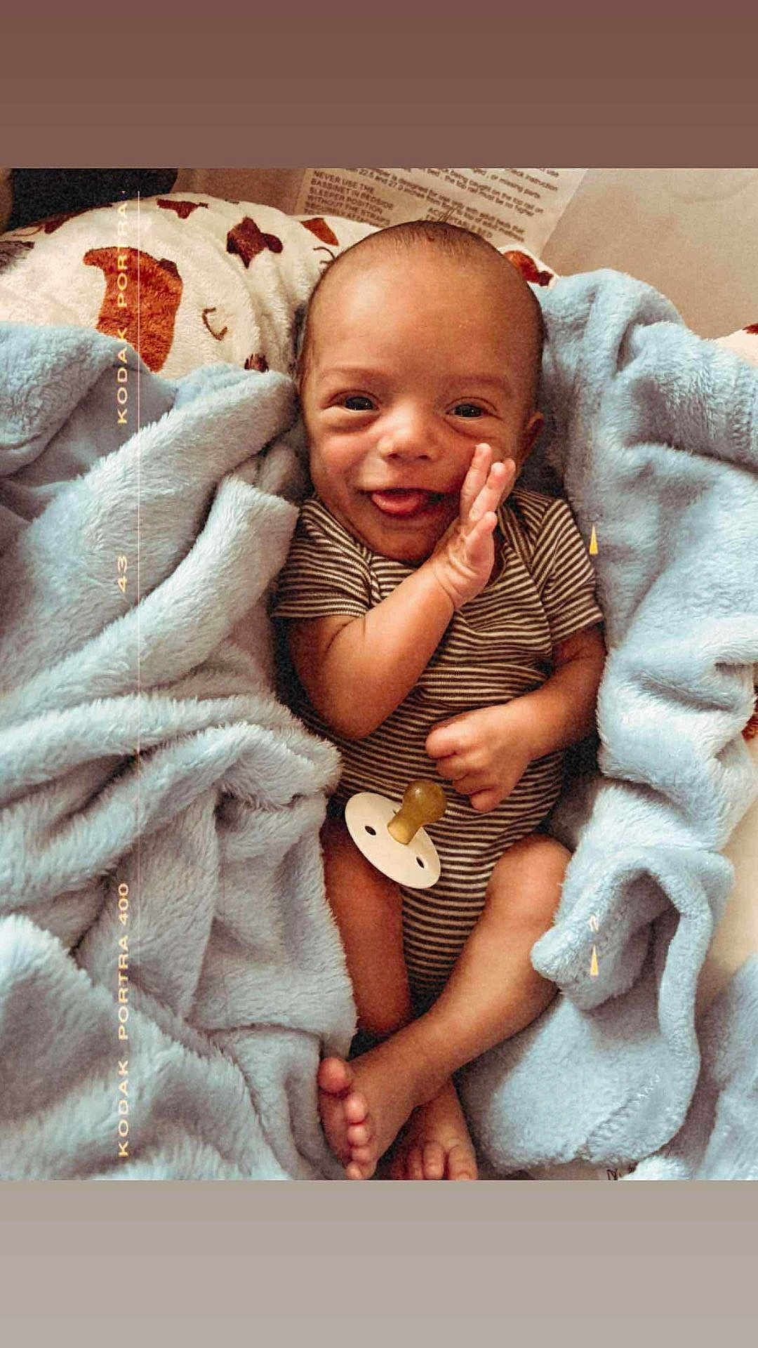 John Luke joined the competition — help win amazing prizes! baby, infant, smile, blanket, pacifier, striped_clothing, hand, foot, cozy, cute, wrapped, soft_texture, happy, child, portrait, newborn, lying_down, warm_colors, face, skin