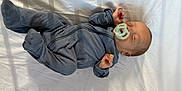 John Luke joined the competition — help win amazing prizes! baby, infant, sleeping, pacifier, onesie, gray_clothing, bed, white_sheet, peaceful, resting, hand, foot, indoors, soft_light, shadow, head, face, newborn, child, person