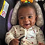 Jenesis is registered to the contest to win money with this photo: baby, child, car_seat, smiling, dimples, onesie, cherry_pattern, safety_belt, infant, happy, cute, indoors, person, seat, toy, head_support, clothing, baby_toy, closeup, portrait