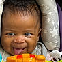Jenesis joined the competition — help win amazing prizes! baby, child, tongue_out, toy, bright_colors, cushion, stars_pattern, cloud_pattern, happy, face, infant, smiling, playful, seat, close_up, indoors, curly_hair, cheerful, person, cute