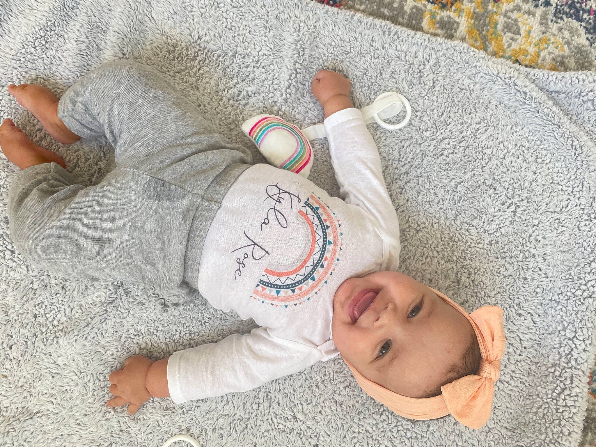 Kyla is registered to the contest to win money with this photo: baby, baby_toddler_clothing, child, comfort, finger, flooring, font, grass, grey, hand, happy, linens, person, product, sand, sitting, smile, textile, toddler, tree