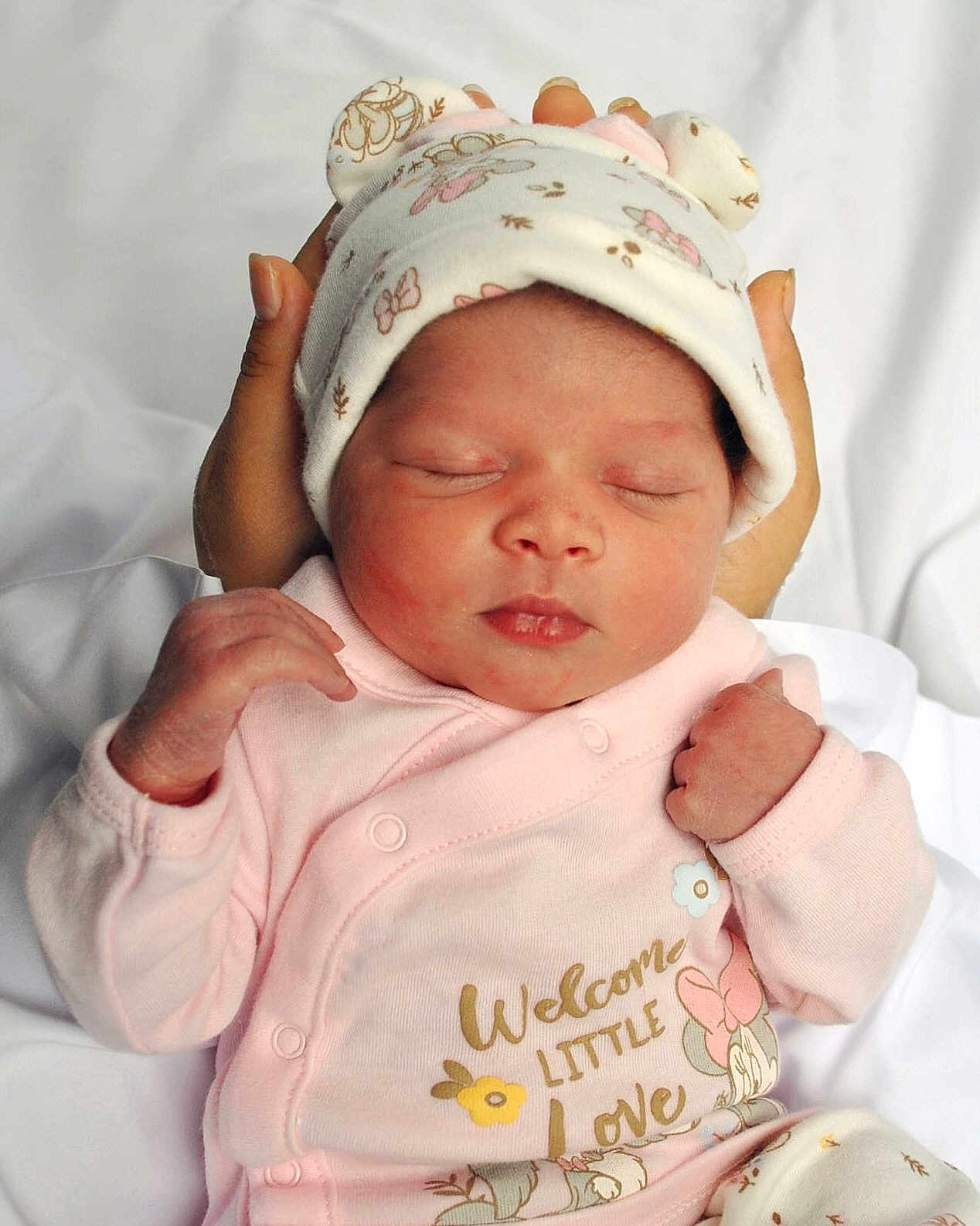 Ty'Arre is registered to the contest to win money with this photo: newborn, baby, infant, sleeping, pink_clothing, hat, hands, cute, peaceful, soft, white_background, closeup, portrait, child, adorable, cozy, wrapped, face, tiny_fist, gentle