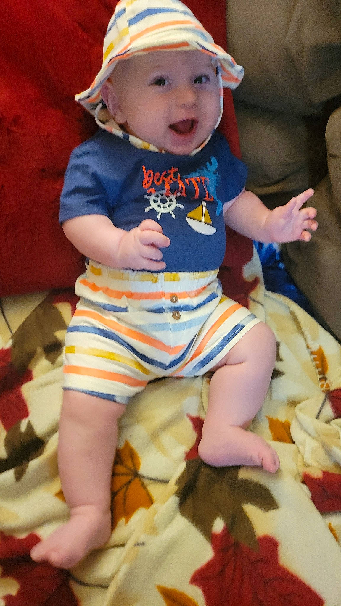 James is registered to the contest to win money with this photo: baby_toddler_clothing, cheek, child, cool, eye, fun, happy, headwear, human_body, human_leg, mouth, orange, pattern, person, pink, shorts, skin, sleeve, smile, t_shirt