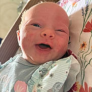 Adalynn joined the competition — help win amazing prizes! baby, baby_girl, blanket, child, closeup, clothing, cute, face, floral_pattern, happy, indoors, infant, lying_down, newborn, pacifier, person, portrait, skin, smiling, soft_lighting