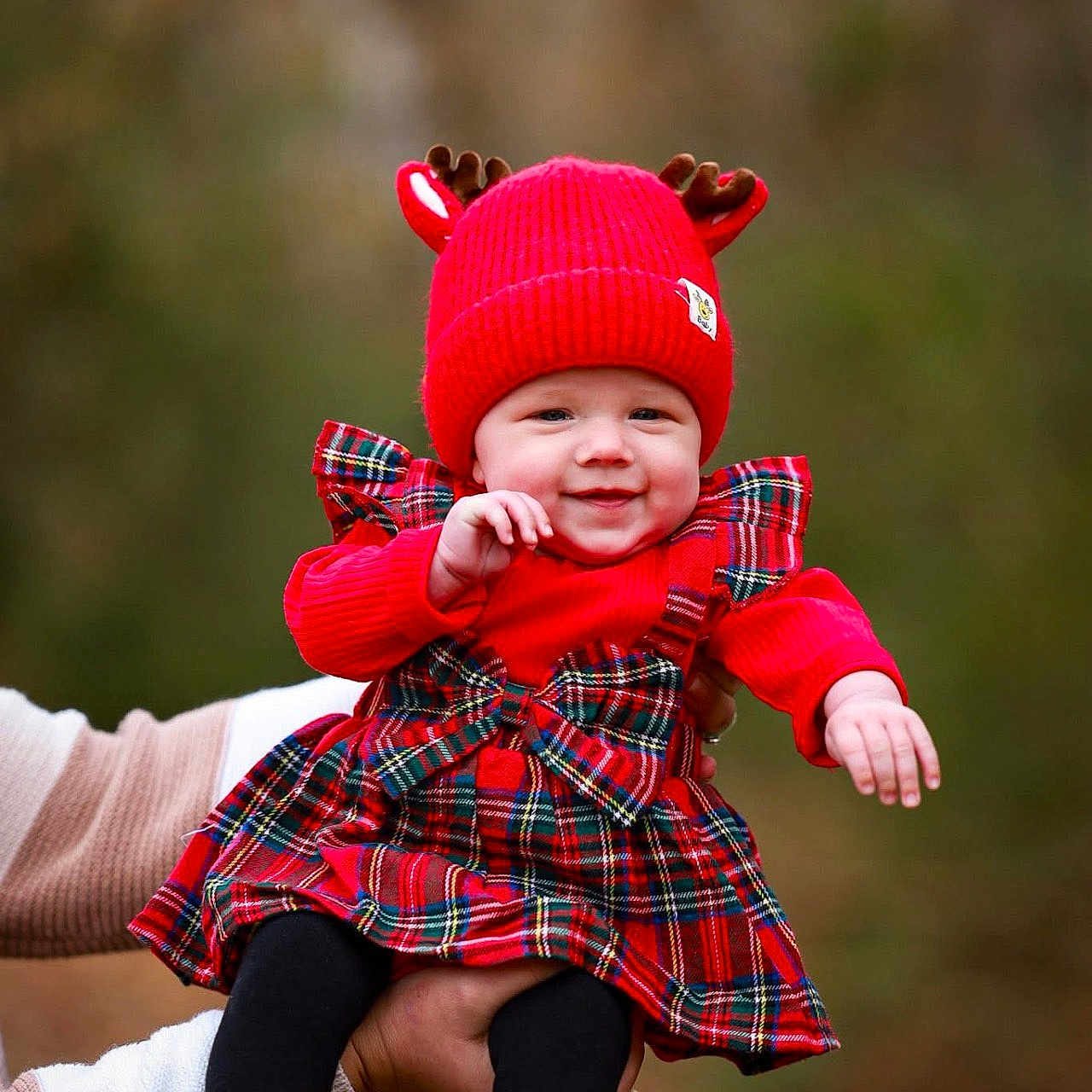 Isabella is registered to the contest to win money with this photo: antlers, autumn, baby, black_tights, child, cute, fall, festive, happy, holding_hands, holiday, nature, outdoor, person, plaid_dress, portrait, red_hat, seasonal, smiling, warm_clothing