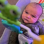 Antonio joined the competition — help win amazing prizes! baby, infant, face, expression, toy, frog, baby_seat, clothing, turtle, pattern, purple_light, closeup, indoor, child, cute, portrait, focus, blur, playful, seated