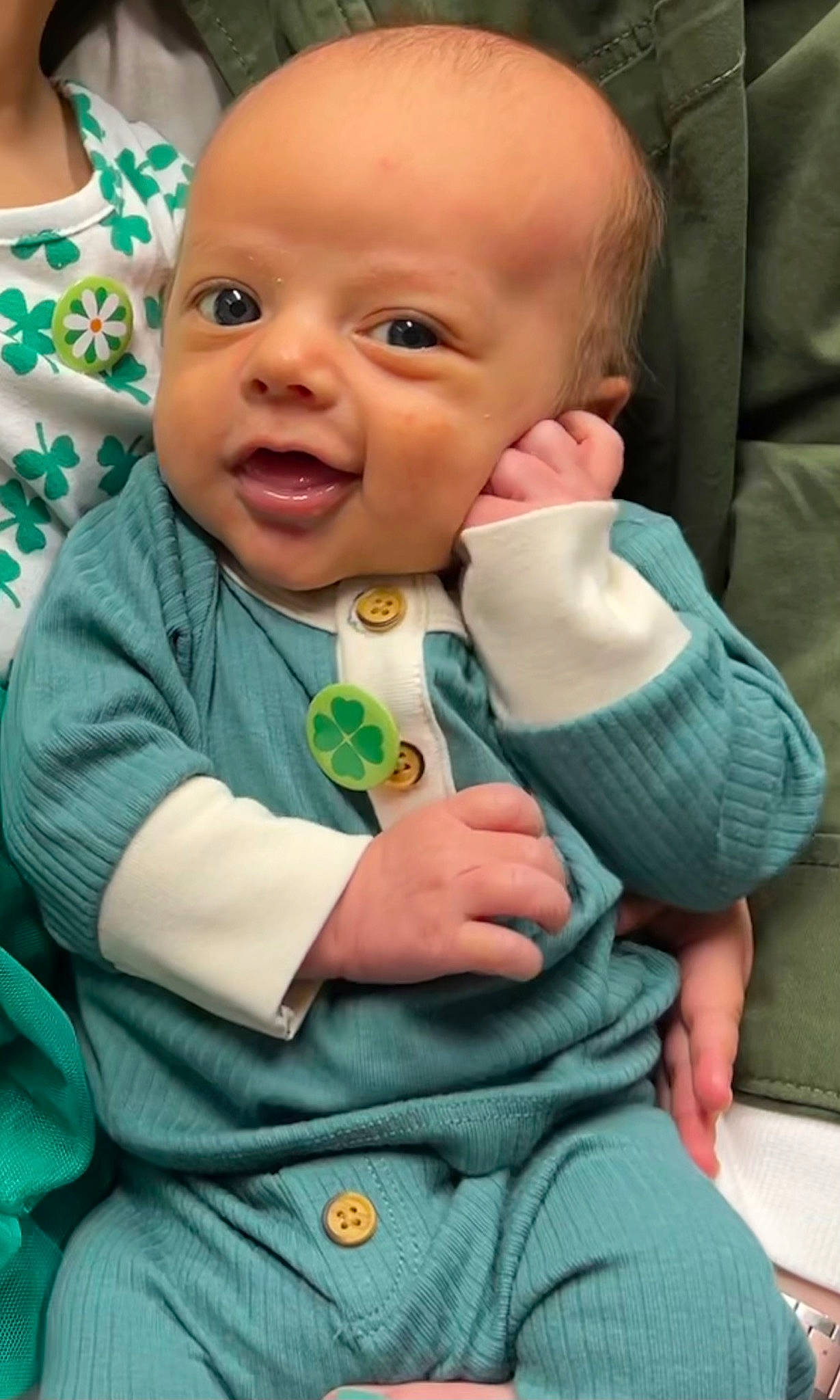 Mekkiah joined the competition — help win amazing prizes! baby, baby_products, baby_toddler_clothing, cheek, child, chin, comfort, facial_expression, finger, gesture, green, happy, nose, outerwear, person, sitting, skin, sleeve, smile, thumb