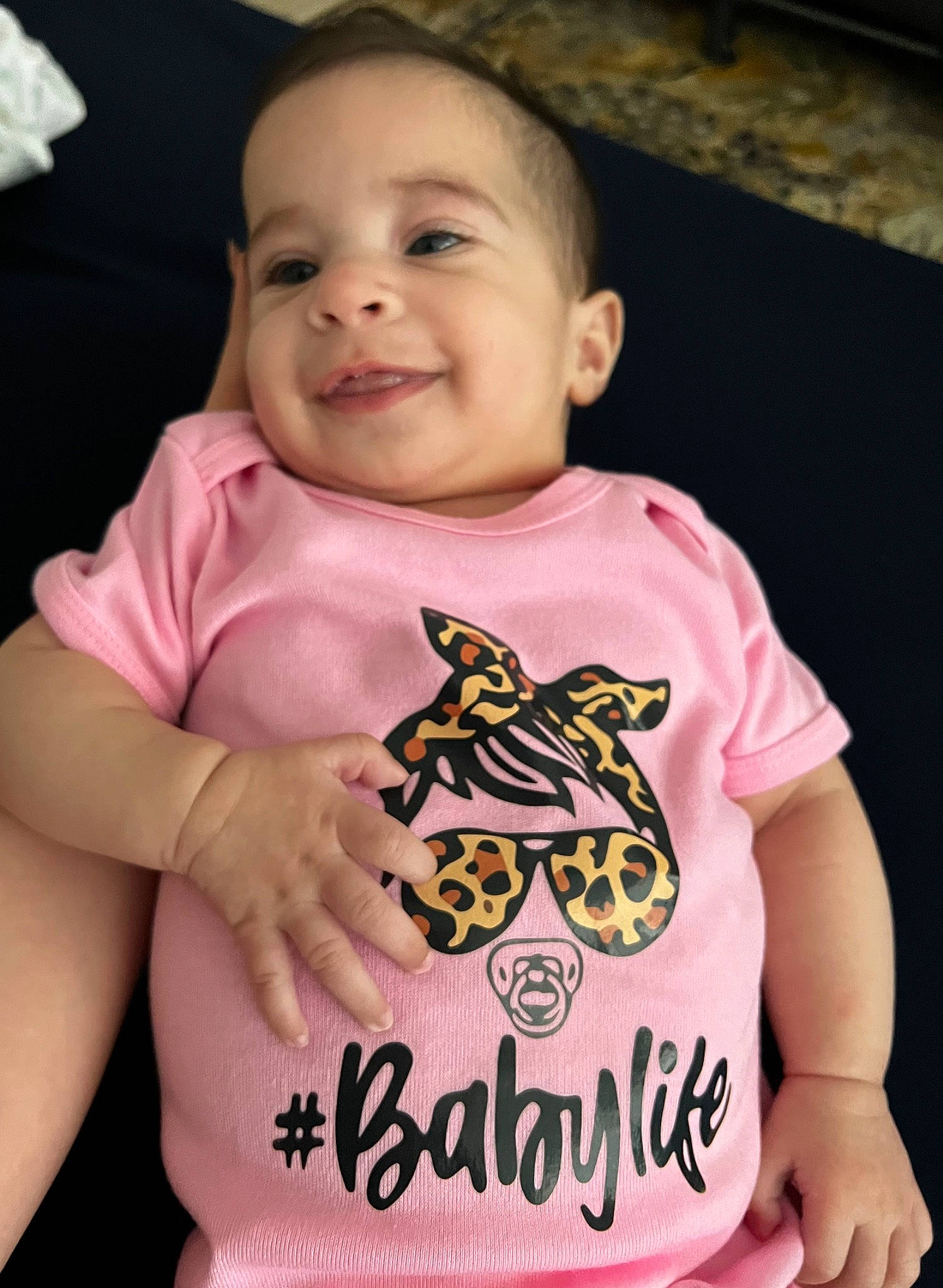 Star K is registered to the contest to win money with this photo: arm, baby, baby_toddler_clothing, cheek, child, cool, eye, finger, hand, happy, head, human_body, mouth, neck, person, pink, skin, sleeve, smile, t_shirt