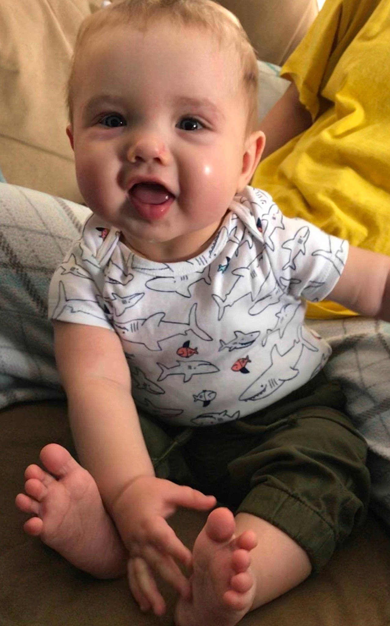 Drake is registered to the contest to win money with this photo: baby, cheek, child, chin, eye, face, finger, head, leg, lip, mouth, nose, person, sitting, skin, smile, toddler
