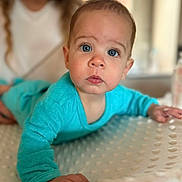 Martin participe au concours pour gagner de l'argent avec cette photo : baby, child, blue_onesie, face, eyes, hand, infant, person, portrait, smile, texture, adult, background, curious, crawling, indoor, soft_light, blanket, focus, closeup