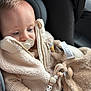Kaïs participe au concours pour gagner de l'argent avec cette photo : baby, pacifier, car_seat, plush_toy, bead_chain, jacket, clothing, child, infant, cute, soft_texture, warm_clothing, seatbelt, indoor, portrait, hand, face, person, closeup, cozy