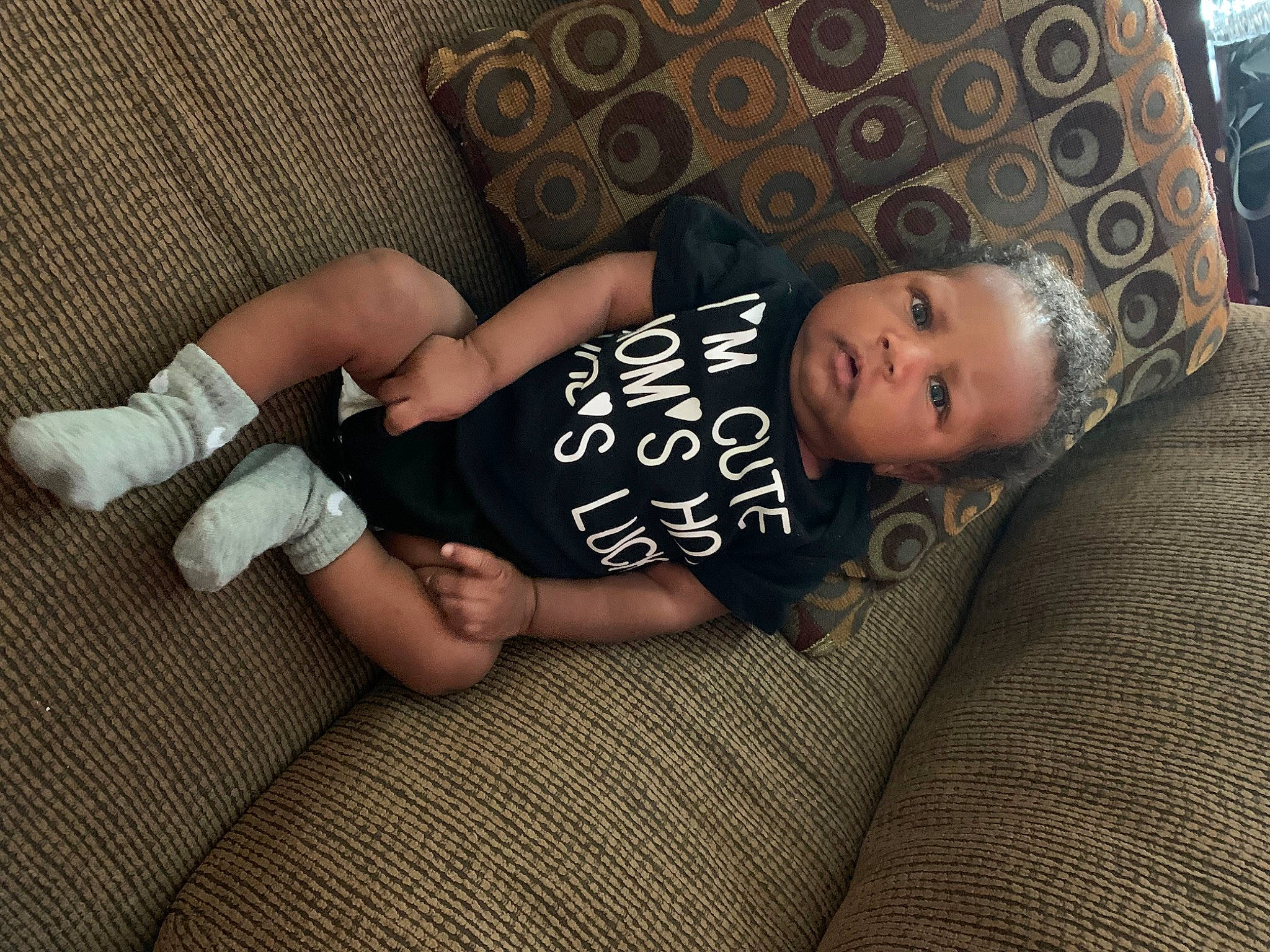 Raiden joined the competition — help win amazing prizes! baby, baby_toddler_clothing, child, comfort, couch, flash_photography, flooring, foot, hat, human_leg, knee, linens, pattern, person, sitting, sleeve, sock, thigh, toddler, wood