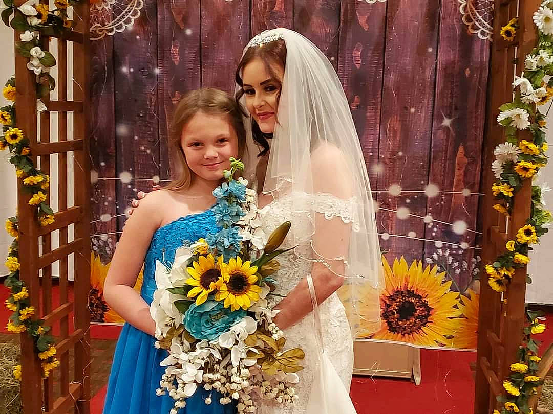 Haylie joined the competition — help win amazing prizes! bridal_clothing, bridal_party_dress, bridal_veil, bride, clothing, dress, facial_expression, fashion, flower, flower_arranging, gown, happy, iris, joy, orange, person, petal, photograph, plant, smile