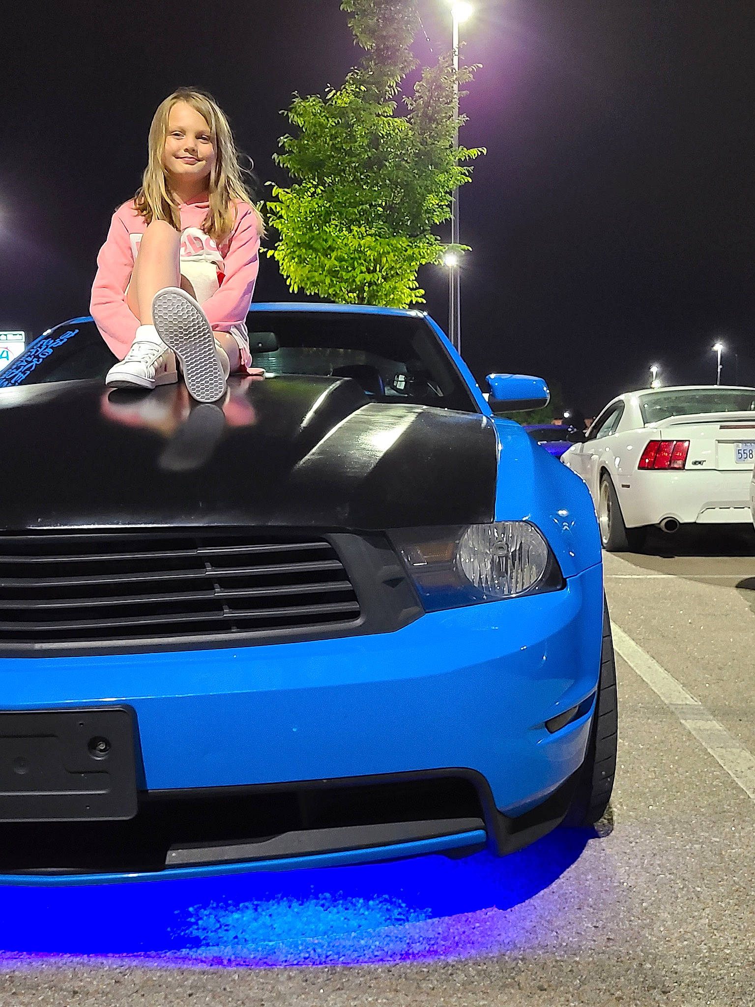 Haylie is registered to the contest to win money with this photo: alloy_wheel, automotive_design, automotive_exterior, automotive_lighting, automotive_tire, bumper, car, flash_photography, grille, hair, headlamp, hood, jeans, joy, land_vehicle, light, motor_vehicle, person, tire, vehicle