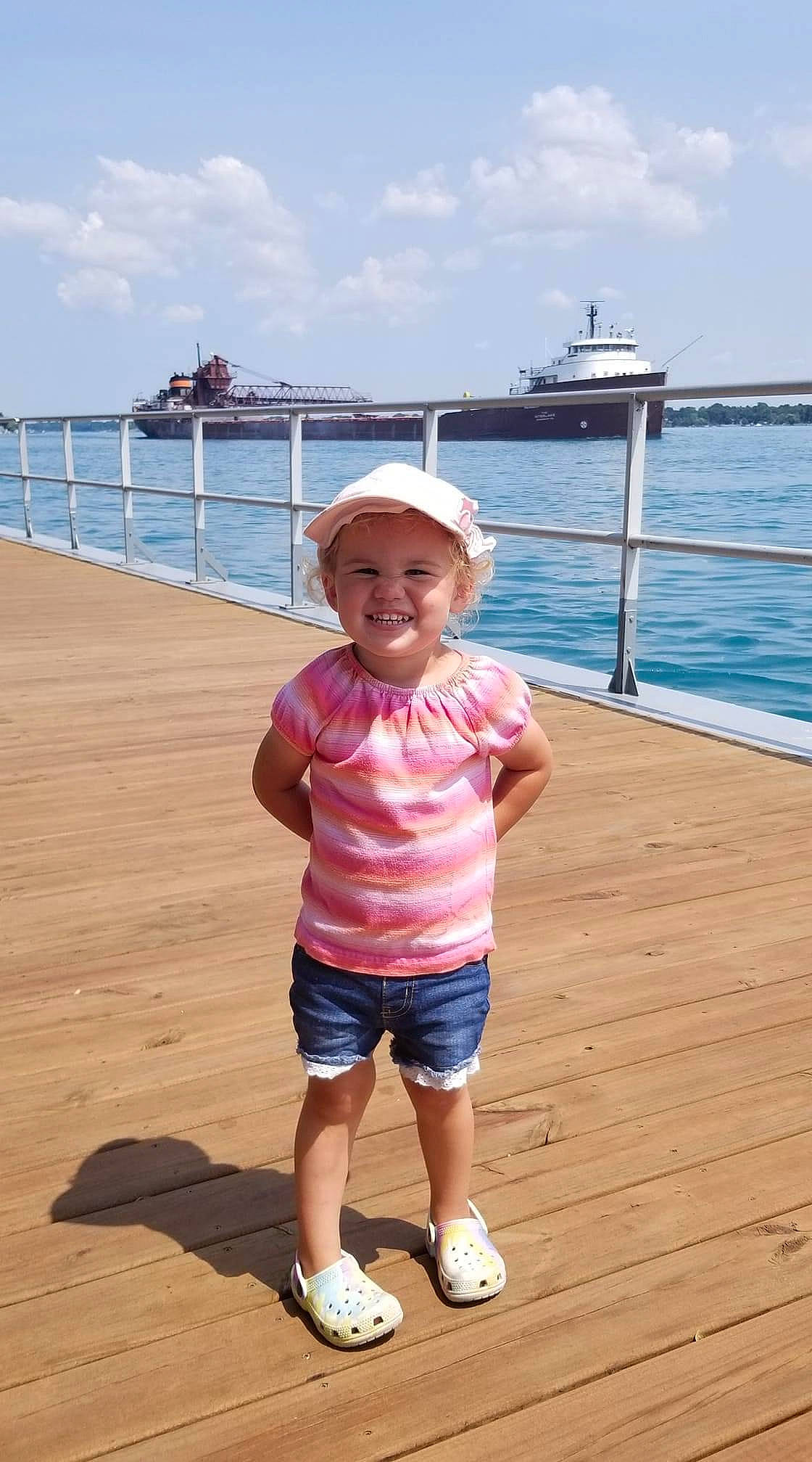Paige joined the competition — help win amazing prizes! baby_toddler_clothing, blue, boat, body_of_water, cloud, footwear, fun, happy, hat, headgear, headwear, joy, leisure, person, shorts, sky, sleeve, smile, toddler, travel