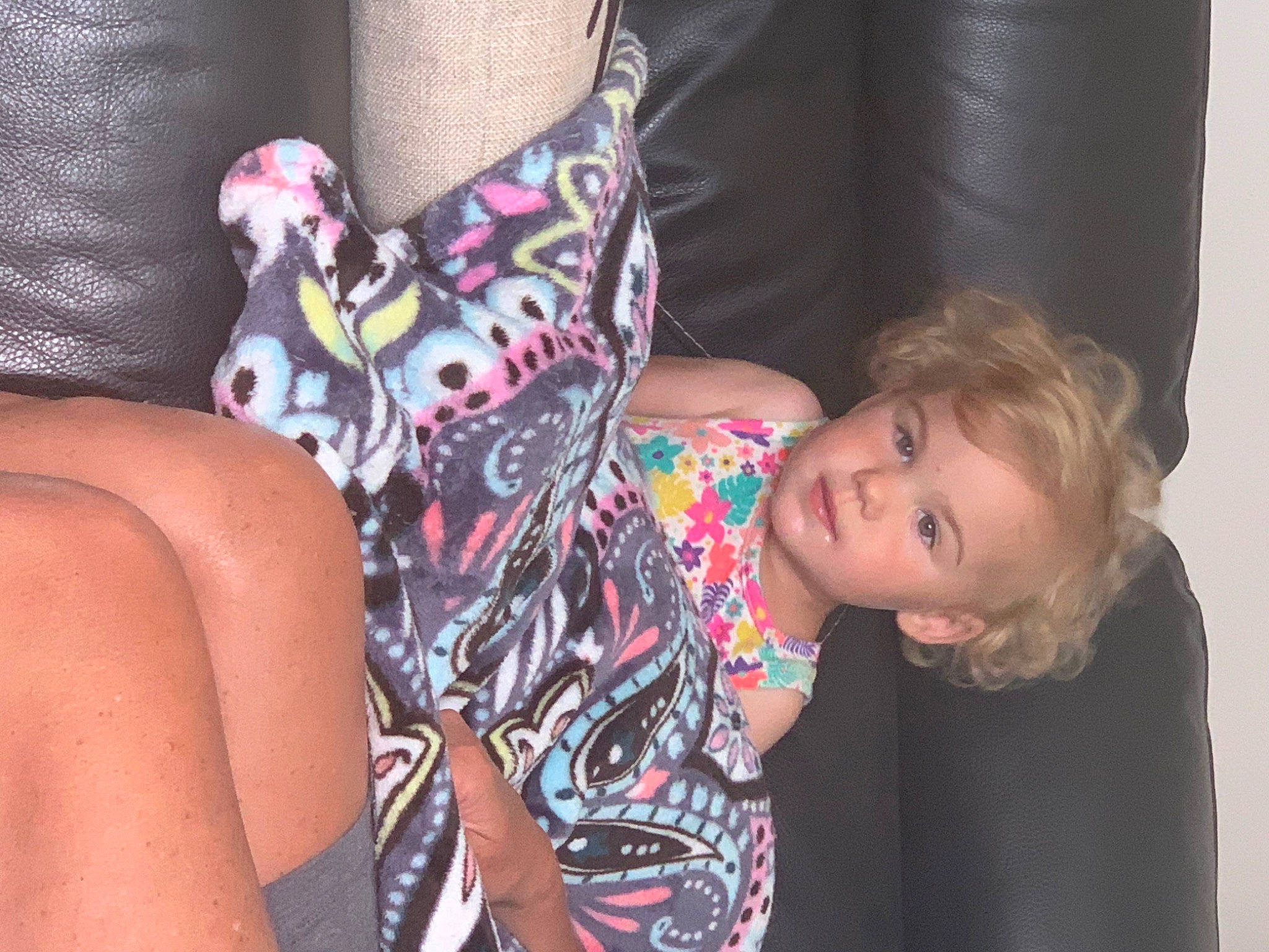 Paige is registered to the contest to win money with this photo: arm, comfort, couch, dress, eye, finger, fun, hand, head, human_body, joint, leg, neck, person, shoulder, sunglasses, textile, thigh, toddler, trunk