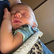 Bodie is registered to the contest to win money with this photo: baby, newborn, sleeping, arm, blanket, leopard_print, cozy, infant, child, person, skin, closeup, rest, peaceful, indoor, soft, cuddle, comfort, tender, portrait