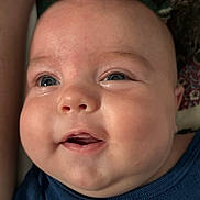 Corbin joined the competition — help win amazing prizes! baby, child, face, blue_eyes, chubby_cheeks, smiling, close_up, infant, apparel, navy_shirt, text_on_clothing, happy, cute, skin, portrait, person, indoors, human, expression, young