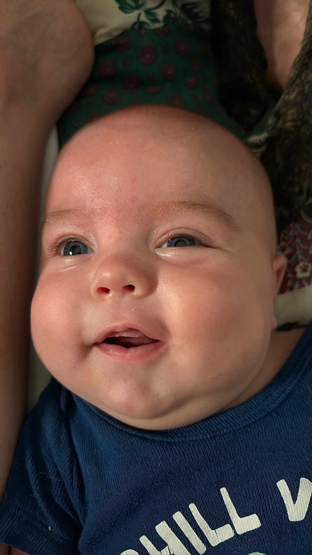 Corbin joined the competition — help win amazing prizes! baby, child, face, blue_eyes, chubby_cheeks, smiling, close_up, infant, apparel, navy_shirt, text_on_clothing, happy, cute, skin, portrait, person, indoors, human, expression, young