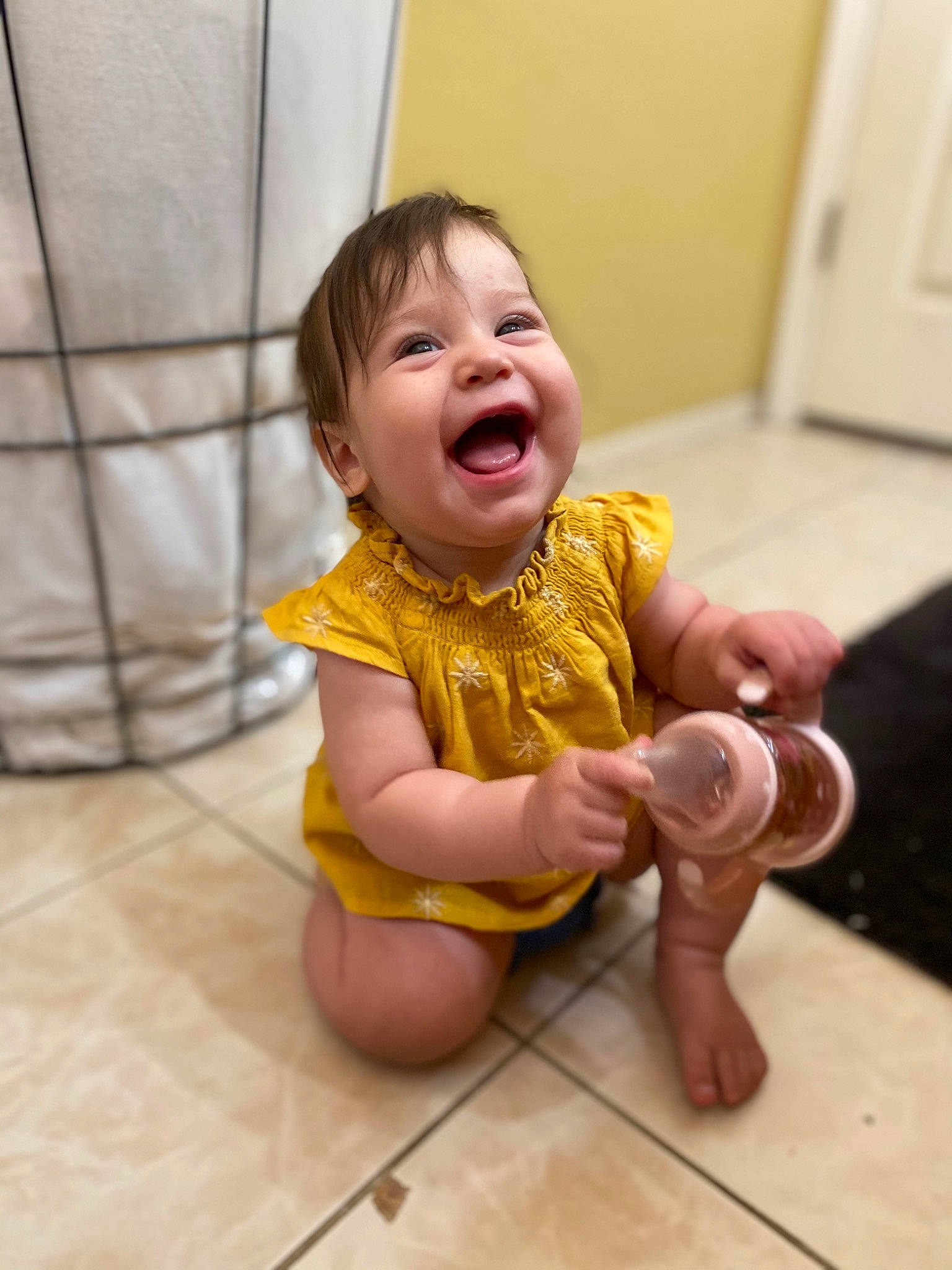 Aspynn is registered to the contest to win money with this photo: arm, baby, baby_laughing, baby_toddler_clothing, cheek, child, comfort, dress, floor, flooring, foot, fun, happy, human_leg, person, pink, skin, smile, thumb, toddler