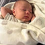 baby, sleeping, blanket, polka_dot, infant, soft, cozy, face, peaceful, rest, bed, cute, child, wrapped, comfort, skin, head, hand, nap, indoors