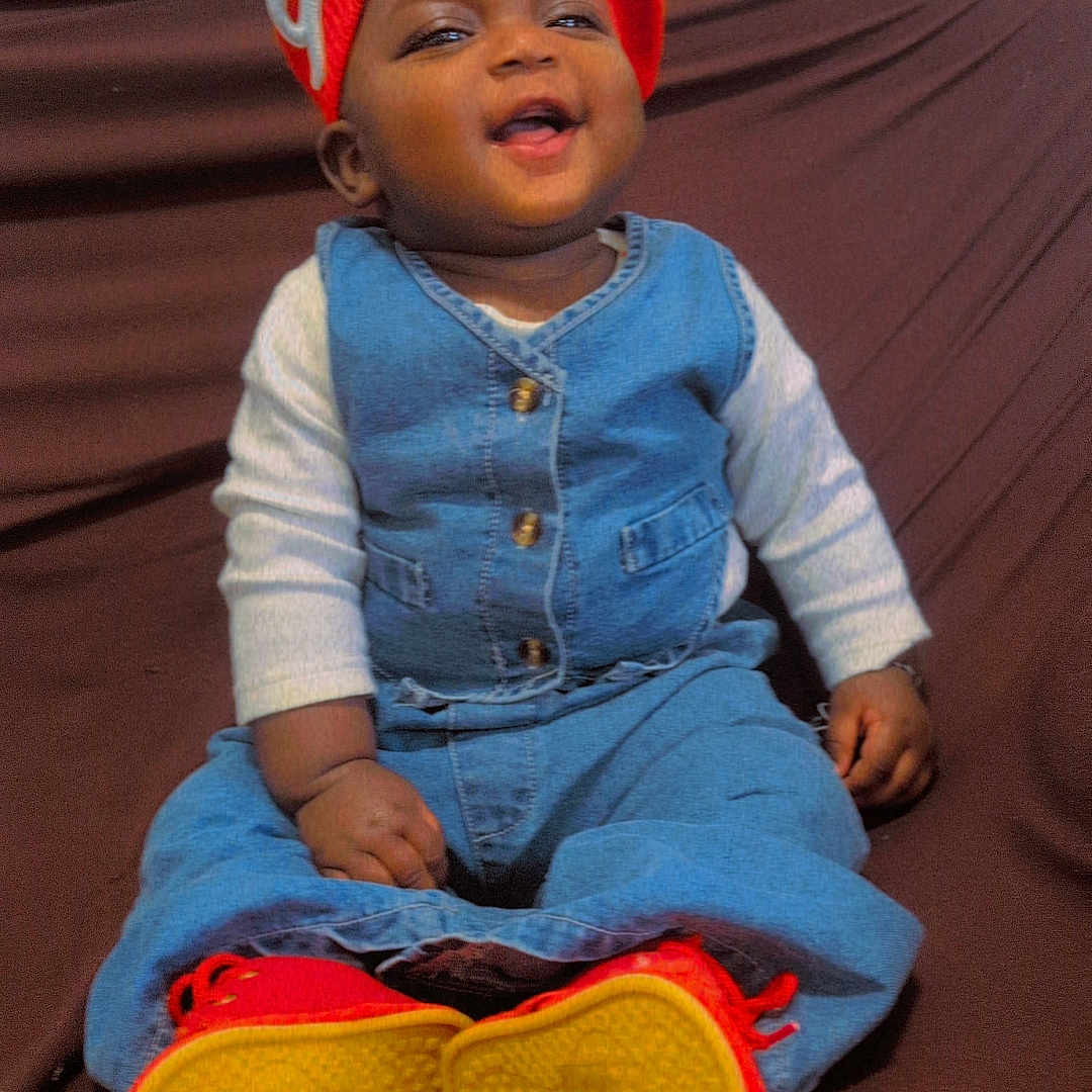 Fatoumata participe au concours pour gagner de l'argent avec cette photo : baby, casual, child, clothing, colorful, couch, cozy, cute, denim_outfit, footwear, happy, heart_emoji, indoors, infant, portrait, red_beret, red_shoes, sitting, smiling, yellow_sol