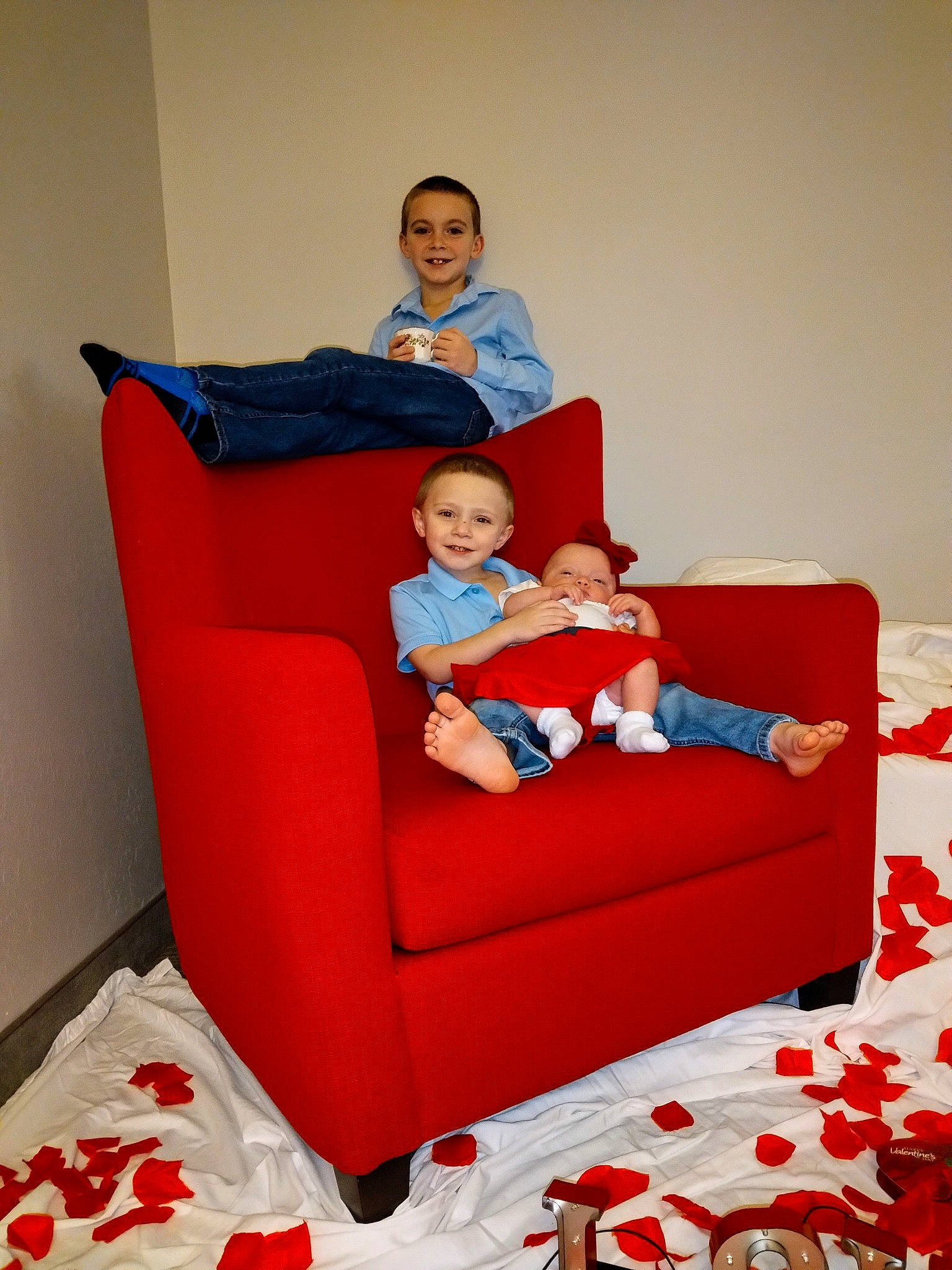 Landon is registered to the contest to win money with this photo: baby, baby_toddler_clothing, carmine, chair, child, comfort, couch, electric_blue, event, fun, happy, joy, lap, leisure, living_room, person, red, room, sitting, smile