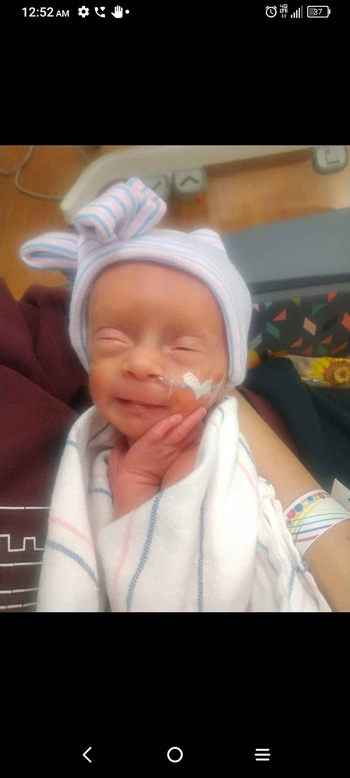 Joy is registered to the contest to win money with this photo: baby, baby_sleeping, cheek, child, comfort, eyebrow, fashion_accessory, fun, happy, laugh, linens, mouth, person, photo_caption, portrait_photography, room, service, sleeve, smile, thumb