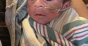 Francisco joined the competition — help win amazing prizes! newborn, baby, infant, hospital, medical, nasal_tube, blanket, hand, person, child, healthcare, care, bed, wrapped, young, face, eyes, skin, hospital_room, patient