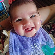 Seven joined the competition — help win amazing prizes! baby, smile, child, purple_bib, pink_bows, pacifier, indoor, person, happy, face, cute, infant, clothing, holding, closeup, headwear, young_child, cheeks, teeth, portrait