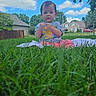 baby, blanket, blue_sky, casual_clothing, child, clouds, daytime, grass, greenery, house, lawn, nature, outdoor, person, portrait, suburban, summer, toddler, tree, young_child