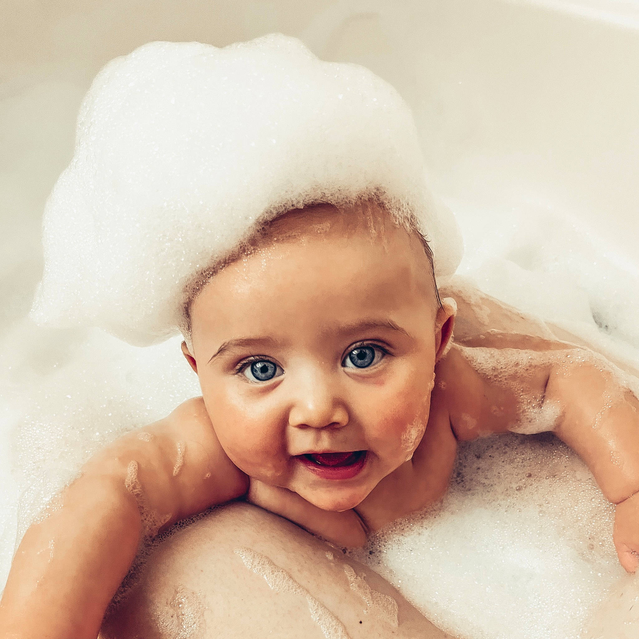 Macie is registered to the contest to win money with this photo: bathing, bathtub, cheek, ear, eye, eyebrow, eyelash, face, finger, foam, gesture, happy, head, iris, jaw, lip, mouth, nose, person, skin