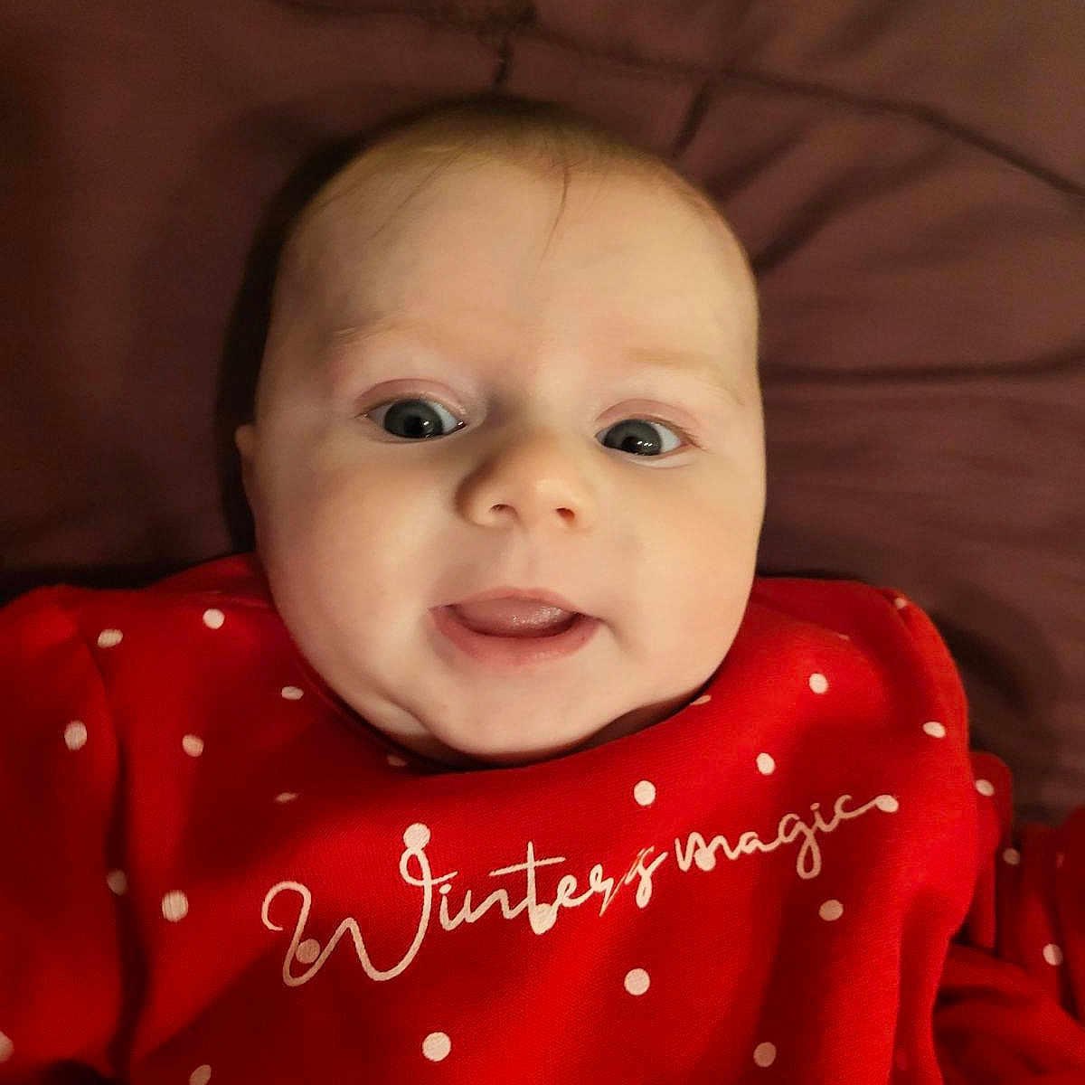 Julia participe au concours pour gagner de l'argent avec cette photo : baby, blanket, clothing, coat, cushion, face, furniture, happy, head, homedecor, laughing, newborn, pajamas, pattern, person, photography, portrait, quilt, smile, t_shirt