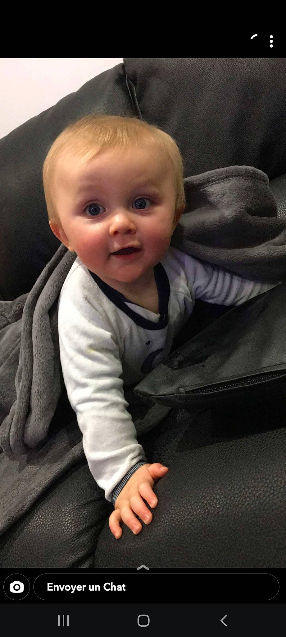 Hugo participe au concours pour gagner de l'argent avec cette photo : baby, baby_toddler_clothing, cheek, child, comfort, face, flash_photography, flooring, grey, head, iris, nose, person, product, sitting, skin, sleeve, smile, surprise, thumb