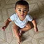 baby, child, floor, patterned_floor, onesie, sitting, blue_eyes, curious, indoor, skin, short_hair, looking_up, hands, feet, cute, infant, person, toddler, young_child, cross_legged