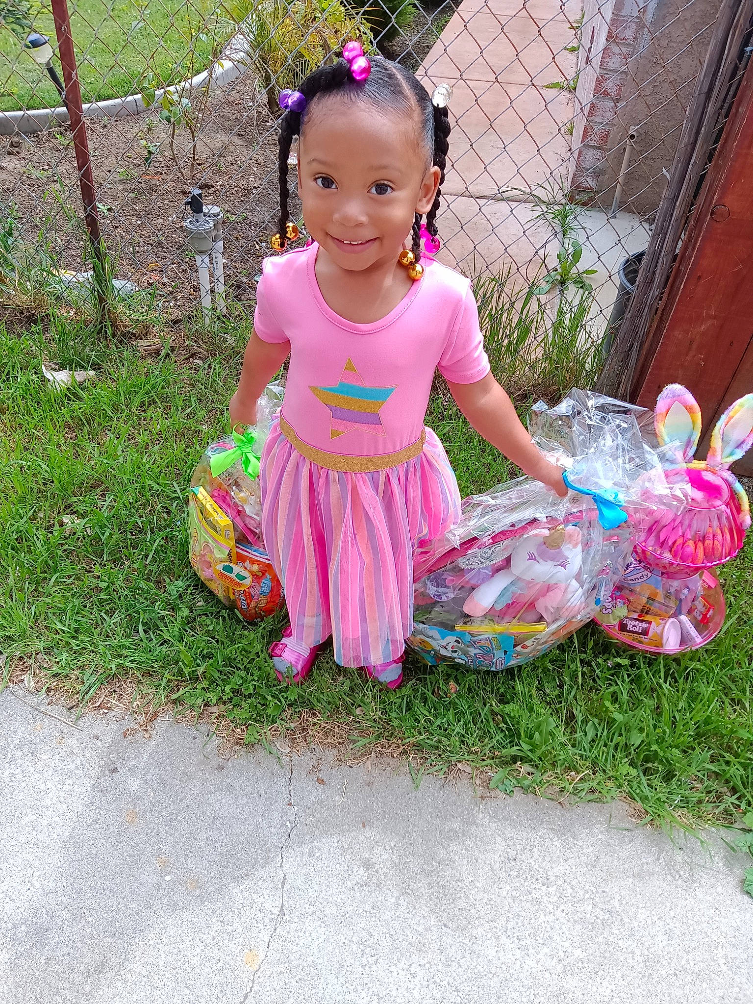 Sariyah joined the competition — help win amazing prizes! baby, baby_toddler_clothing, child, door, fun, grass, happy, joy, leisure, magenta, necklace, pattern, person, pink, plant, play, sandal, sitting, smile, summer