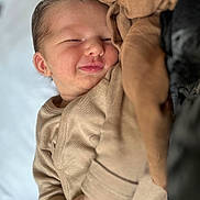 Solann participe au concours pour gagner de l'argent avec cette photo : baby, newborn, smiling, sleeping, infant, cozy, blanket, beige, soft, cute, child, face, peaceful, closeup, portrait, warm, comfort, resting, indoors, young