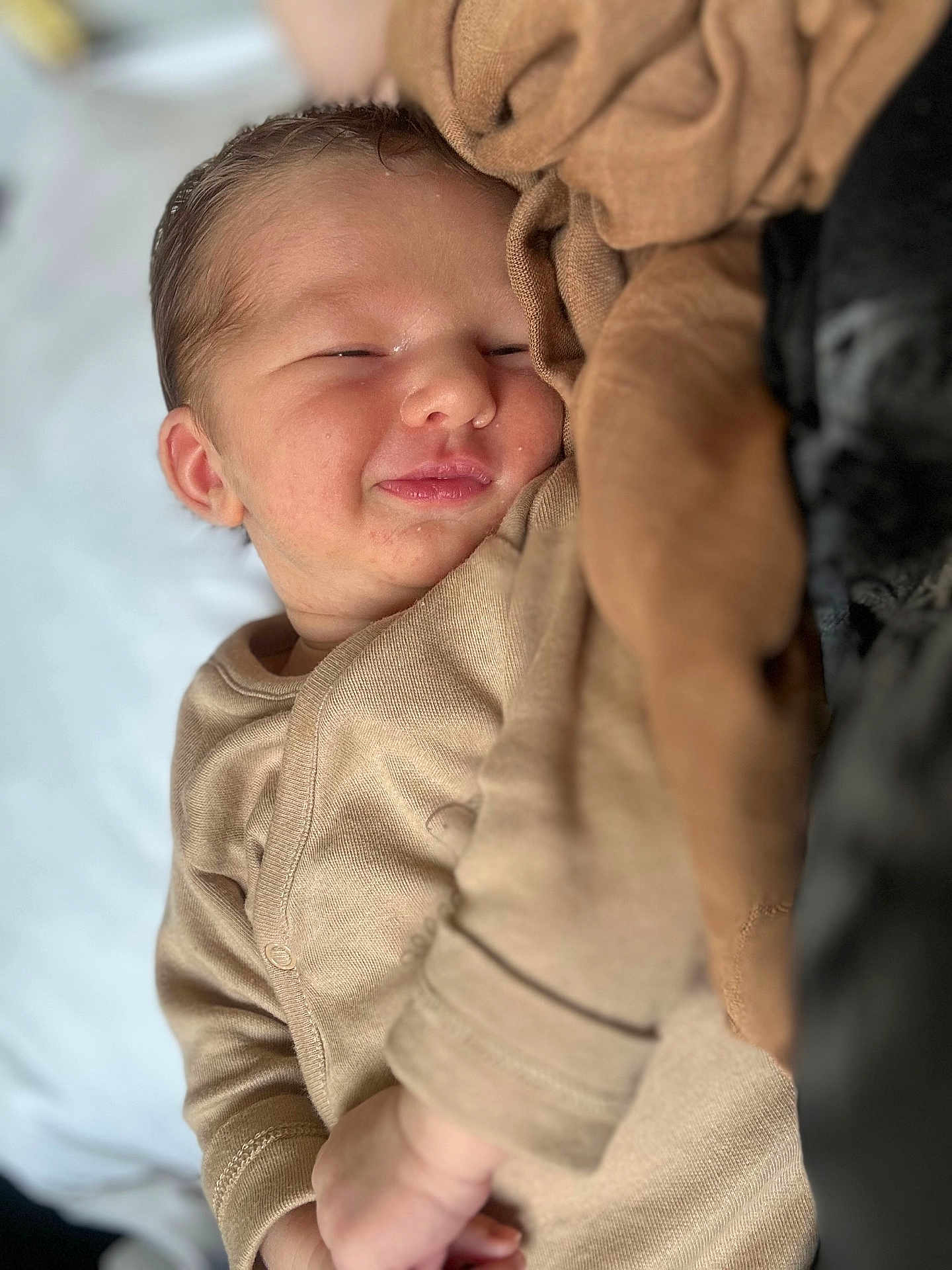 Solann participe au concours pour gagner de l'argent avec cette photo : baby, newborn, smiling, sleeping, infant, cozy, blanket, beige, soft, cute, child, face, peaceful, closeup, portrait, warm, comfort, resting, indoors, young