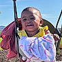 Taelor Burch is registered to the contest to win money with this photo: child, toddler, swing, blanket, yellow_clothing, outdoor, smiling, happy, playground, sunny, sky, park, fun, baby, seat, metal_chain, daytime, grass, person, cute