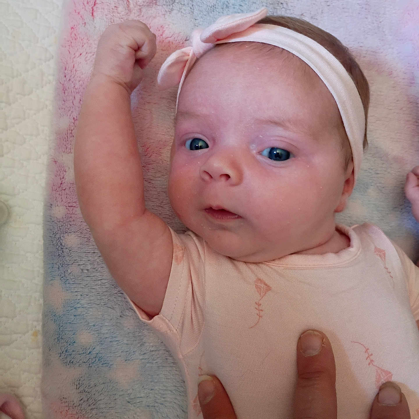 Lilyrose joined the competition — help win amazing prizes! baby, infant, face, blue_eyes, headband, pink, arm, fist, hand, blanket, pastel_colors, clothing, cute, portrait, child, skin, newborn, lying_down, person, soft_texture
