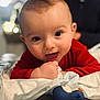 Milo participe au concours pour gagner de l'argent avec cette photo : baby, background_blur, child, close_up, cute, expression, face, focus, hand, happy, indoor, infant, lying_down, person, playful, red_clothing, skin, smiling, soft_lighting, toy