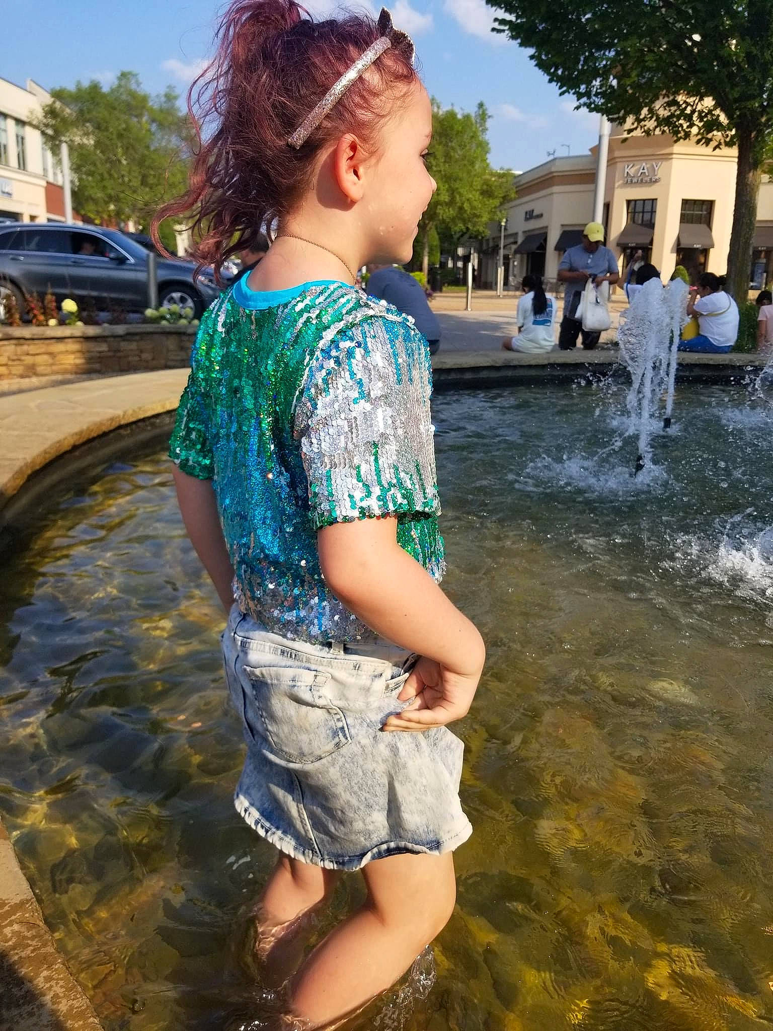 Elayna is registered to the contest to win money with this photo: daytime, fountain, fun, grass, happy, leisure, morning, person, photograph, plant, recreation, shorts, snapshot, summer, t_shirt, travel, tree, waist, water, water_feature