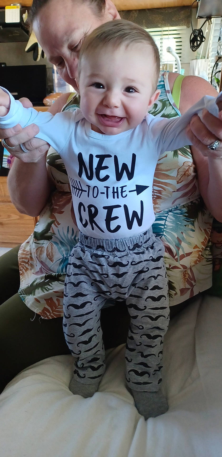 Antonio is registered to the contest to win money with this photo: active_pants, arm, baby_toddler_clothing, finger, gesture, hairstyle, hand, happy, human_body, joint, leg, military_camouflage, neck, organ, person, pink, shoulder, skin, sleeve, smile