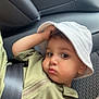 Djibrïl participe au concours pour gagner de l'argent avec cette photo : toddler, child, hat, bucket_hat, seatbelt, car_seat, car_interior, green_shirt, portrait, face, curious, young_child, casual_clothing, sitting, indoor, baby, person, headwear, seat, safety