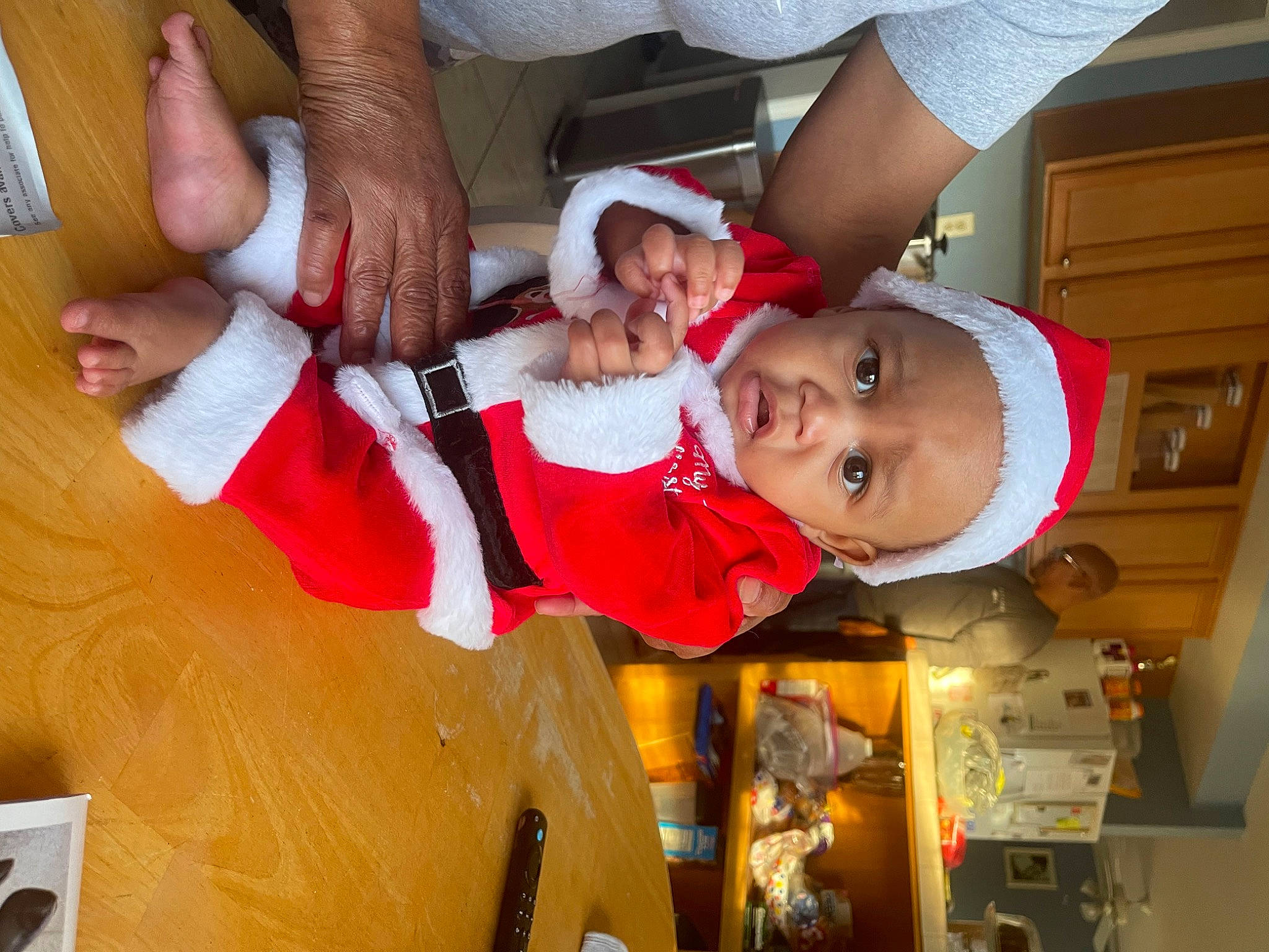 Keith is registered to the contest to win money with this photo: arm, baby, baby_toddler_clothing, child, christmas_eve, event, fun, gesture, happy, hat, holiday, nail, person, sharing, smile, thumb, toddler, tradition, wrist