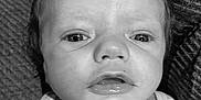 Jaydean joined the competition — help win amazing prizes! baby, infant, face, close_up, black_and_white, blanket, curly_hair, expression, couch, texture, person, portrait, young_child, indoors, clothing, cute, small_hand, striped_shirt, skin, eyes