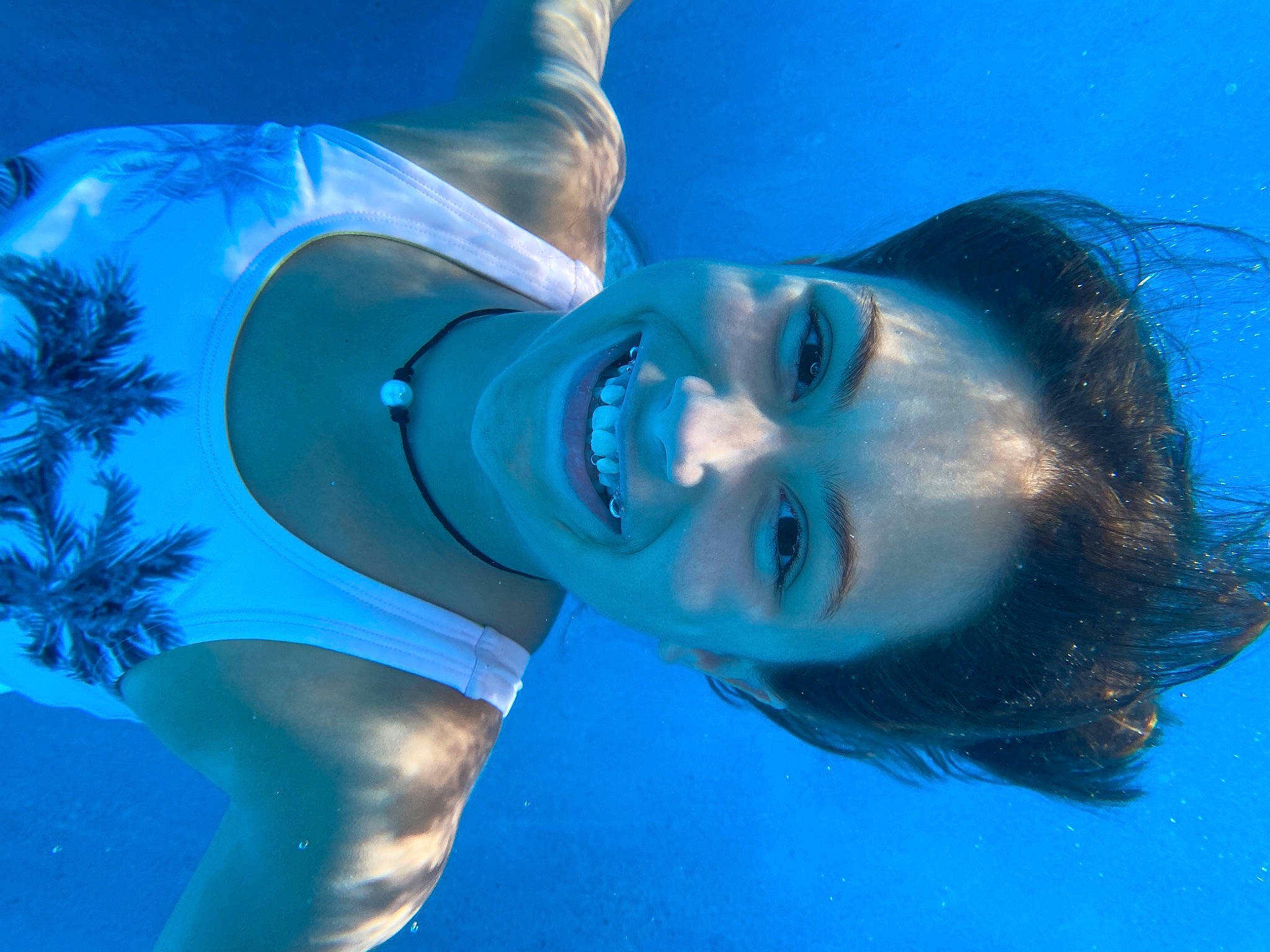 Rylee is registered to the contest to win money with this photo: blue, fun, joy, leisure, mouth, person, recreation, smile, swimming, underwater, water