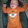 Eliott participe au concours pour gagner de l'argent avec cette photo : baby, sleeping, onesie, orange_clothing, tiger_design, cushion, bed, raised_arms, peaceful, infant, child, indoor, soft_texture, face, head, portrait, cozy, resting, cute, young