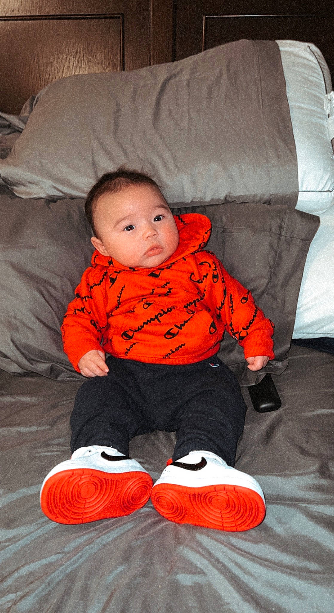 Ellijah joined the competition — help win amazing prizes! baby, baby_toddler_clothing, cheek, child, comfort, face, flooring, fun, knee, lap, linens, orange, person, room, sitting, sleeve, smile, t_shirt, textile, toddler