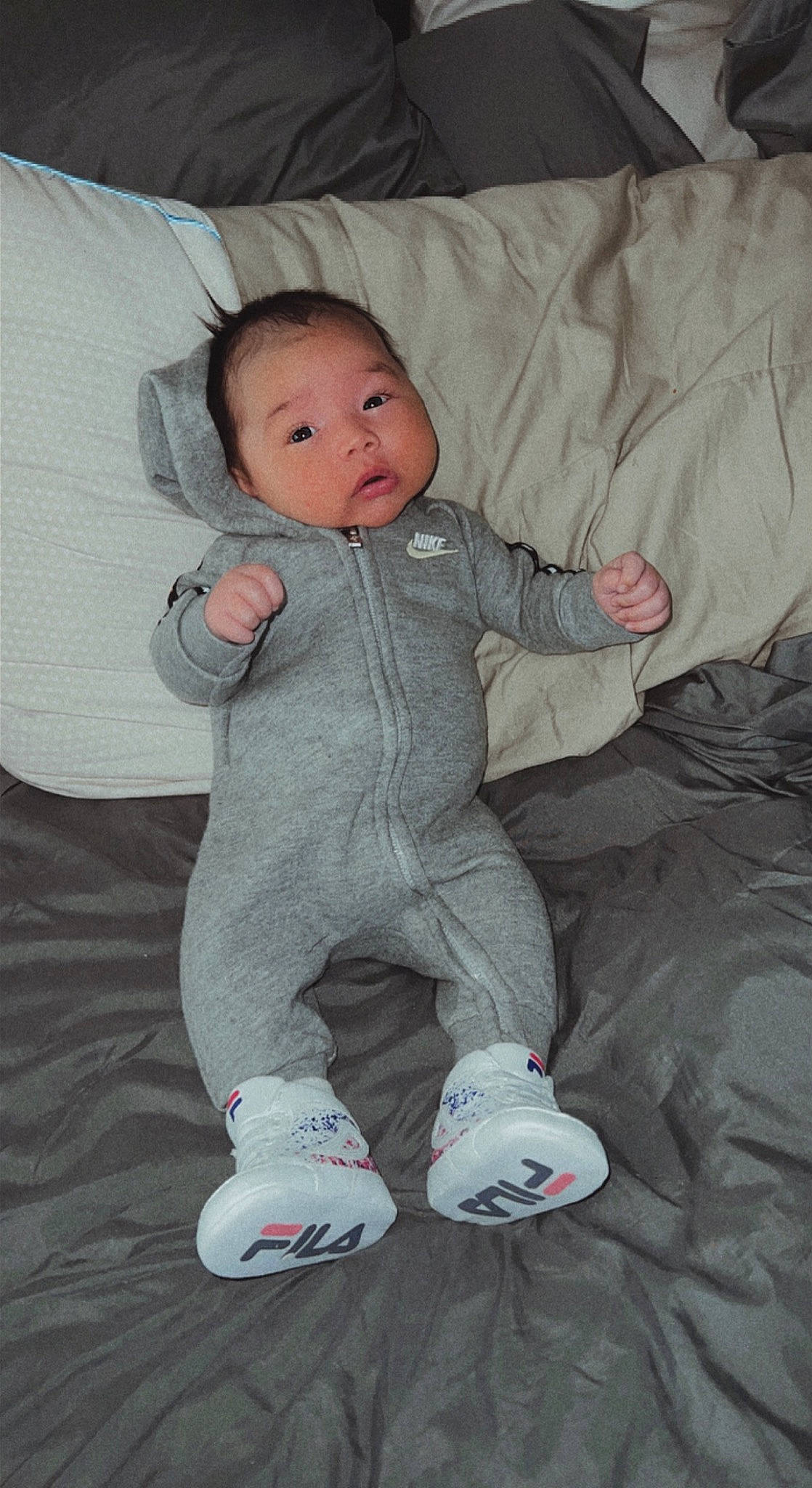 Ellijah joined the competition — help win amazing prizes! baby, baby_toddler_clothing, cheek, child, comfort, face, finger, fun, head, iris, linens, nose, pattern, person, room, sitting, sleeve, sock, toddler, vertebrate